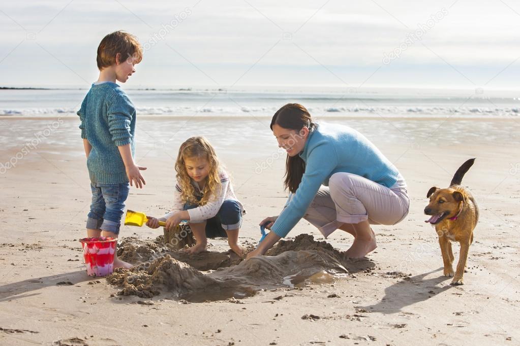 Mother Children and Pet Dog on the Beach