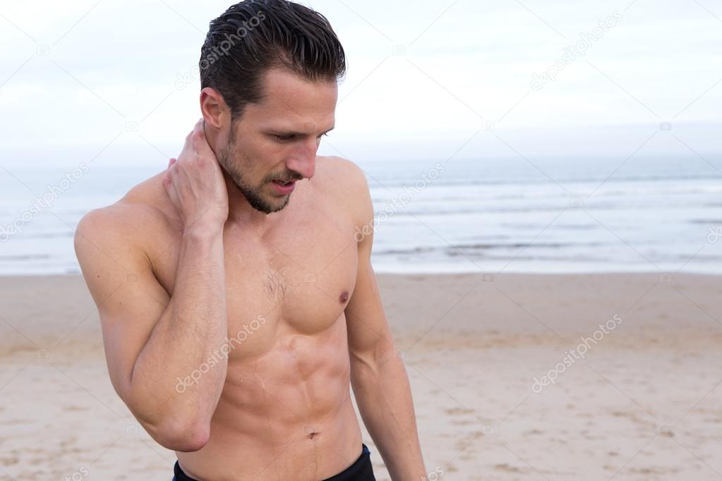 Muscular Surfer on Beach