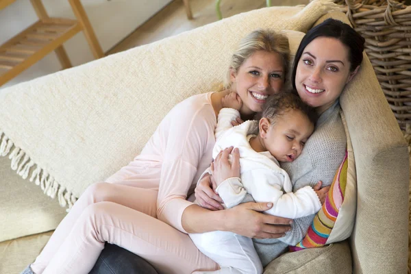 Female couple cuddling with their baby son — Stock Photo, Image
