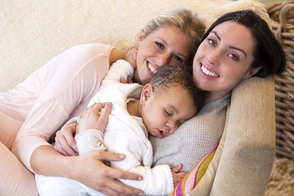 Female couple cuddling with their baby son