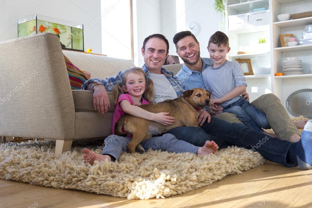 Male couple posing with son, daughter and dog