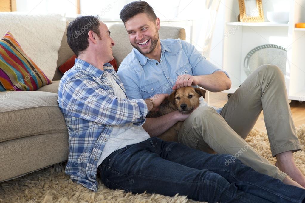 Male couple sitting with their pet dog