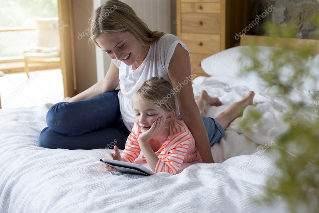 Mother and daughter using a digital tablet together