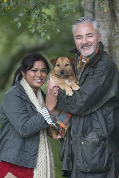 Happy couple with their dog — Stock Photo, Image