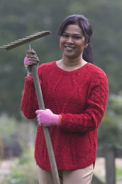 Happy woman in her garden — Stock Photo, Image