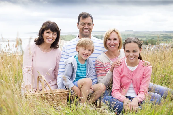 Family sitting on the sand dunes — Stock Photo, Image