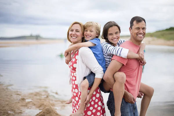 Parents carrying children — Stock Photo, Image