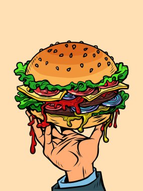 Bir erkeğin elinde lezzetli bir hamburger. sokak yemekleri ve restoranlar