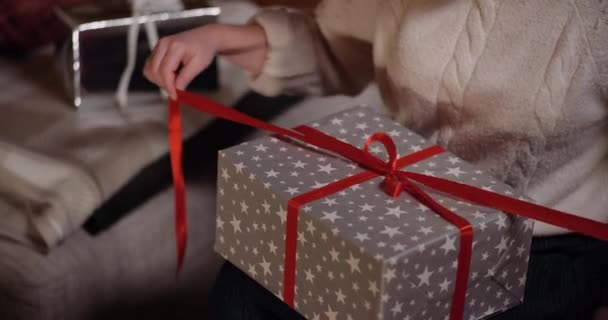 Eröffnungsgeschenk. Frau packt Geschenk zu Weihnachten aus. — Stockvideo