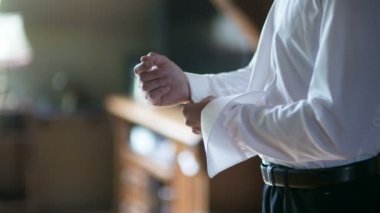 Gömleğin düğmelerini ilikleyen adam. Giyinik adam. Erkekleri giydirmek. Erkek elleri.