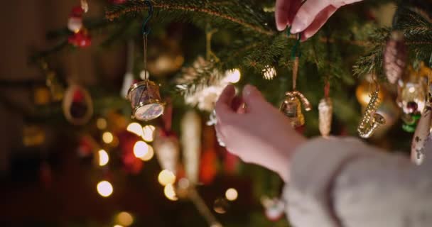 リビングルームで美しいクリスマスツリーを飾る女性。クリスマスの背景. — ストック動画