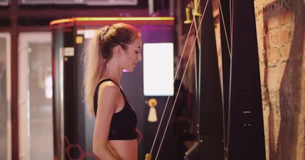 Atleta femenina delgada haciendo ejercicio en el gimnasio — Vídeo de stock