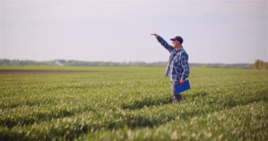 Bir tarımda çalışırken cep telefonuyla konuşan çiftçi