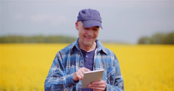 Farmer Examinando Campo Agrícola Enquanto Trabalhando em Computador Tablet Digital na Fazenda. — Vídeo de Stock