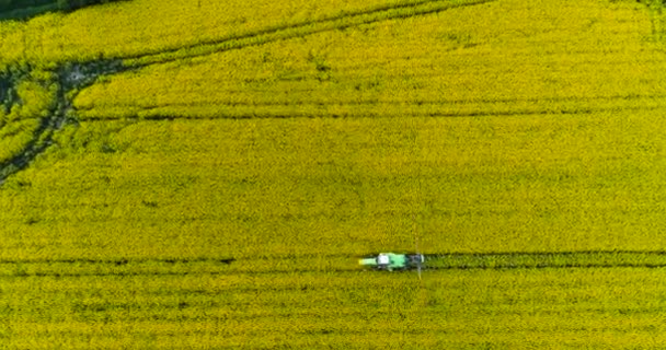 Tractor spraying field. — Stock Video