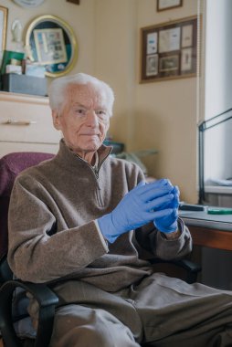 Covid-19 'a karşı koruyucu eldiven takan ihtiyarın portresi