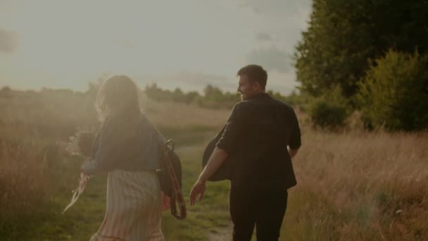 Affectionate Hipsters Walking and Smiling in Summer at Sunset — Vídeo de Stock