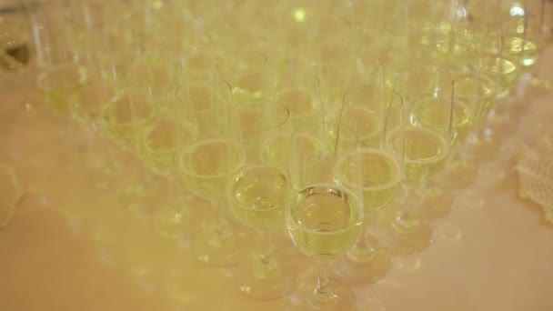 Decorated champagne flutes on table during wedding — Stock Video