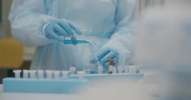 Close-up of scientists hands performing an experiment in a medical lab. Focus on biotechnology and biology analysis.