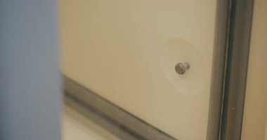 Close-up of a woman opening a specialized medical freezer containing special medical samples.