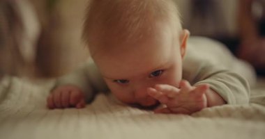 Adorable baby smiles and begins to crawl towards the camera. A heartwarming and emotional moment captured.