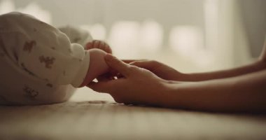 A touching moment of a mother gently touching her newborn babys soft and delicate little feet, symbolizing new life and parenthood.