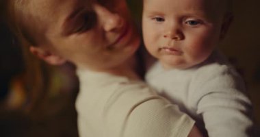 A joyful mother cuddling and playing with her infant on a blanket, capturing moments of happiness, parenthood, and strong emotional bonds.