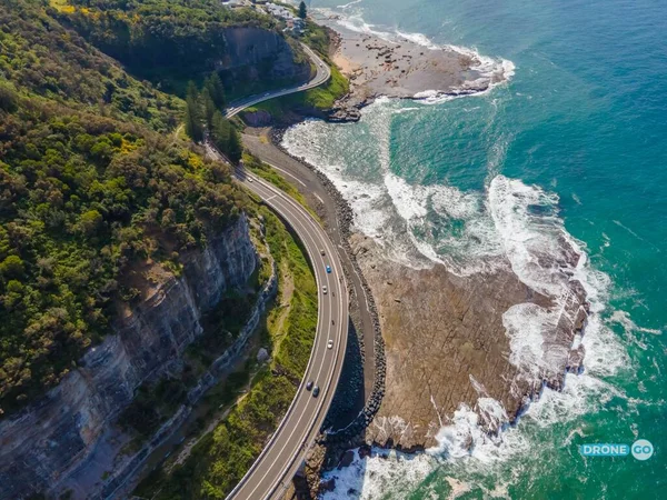 Drone aerial photo of famous Sea Cliff Bridge washed up by surf on a sunny Sunday afternoon in Illawarra area of the New South Wales, Australia