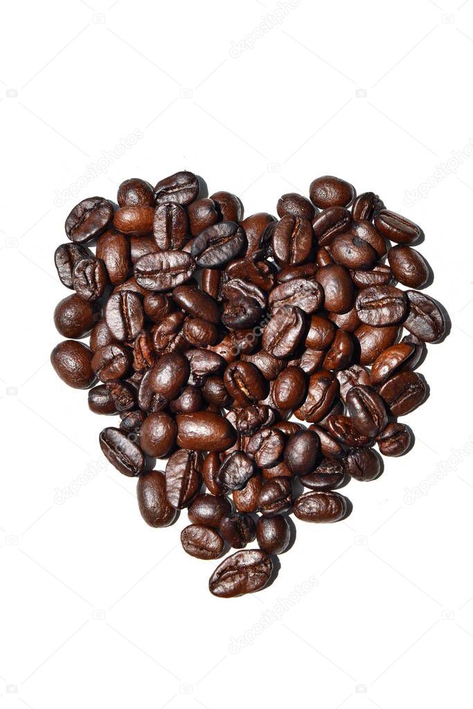 Close-up Heart symbol from pile of Dark brown roasted coffee beans isolated on white background, Raw processed food for drinks refreshment