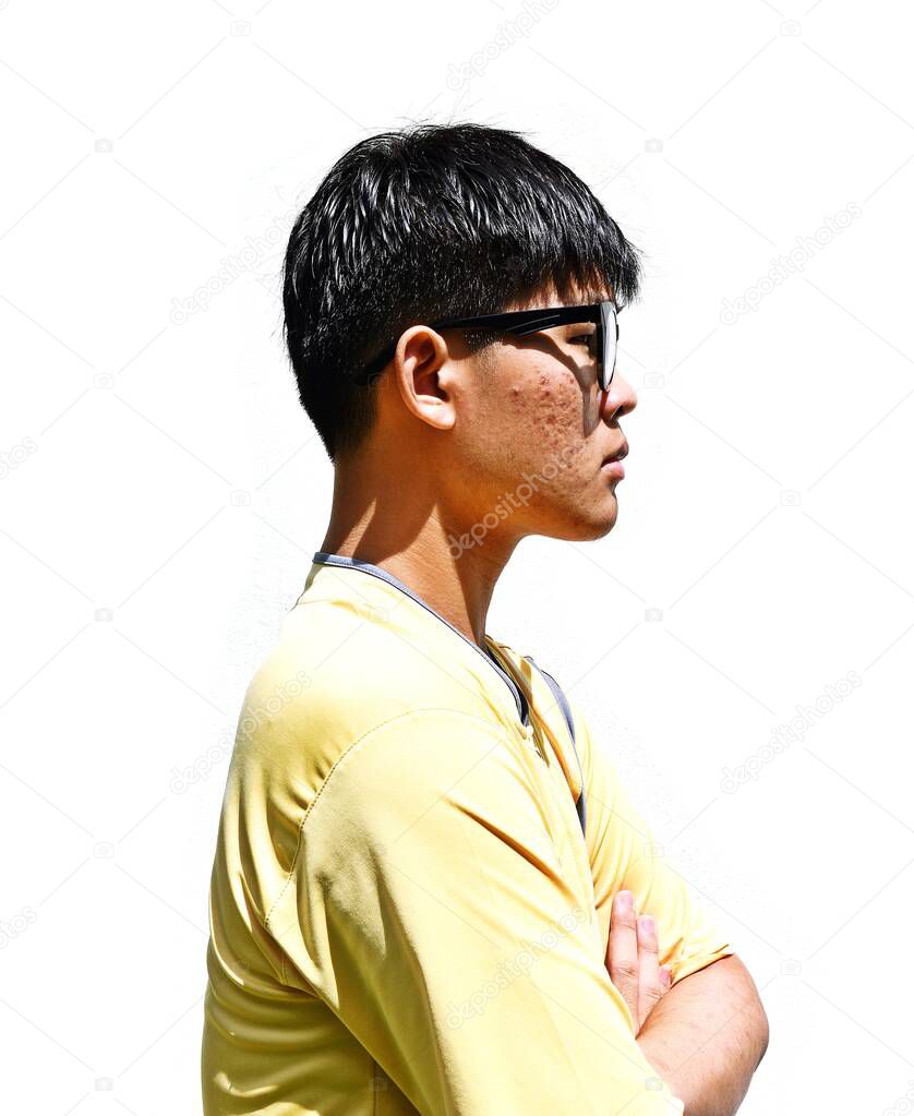 Side Portrait of Asian teenage men, New generation in Asia, Teenagers wear black frame glasses, Thai teen people wearing yellow shirt on white background, Acne-prone face of adolescent male