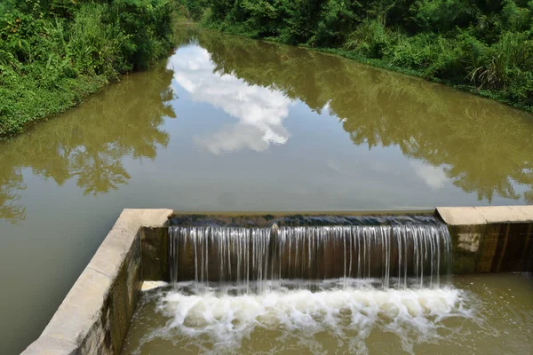 Turbid water in the check dam overflows into the spillway, Thailand