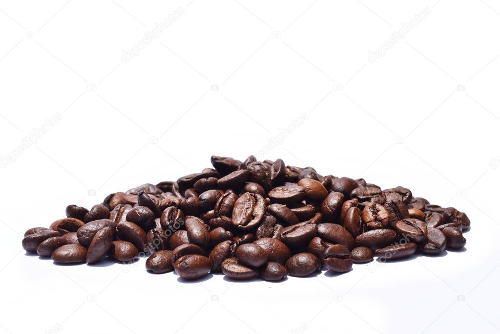 Pile of Dark brown roasted coffee beans isolated on white background, Raw processed food for drinks refreshment