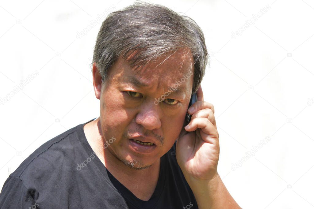 Asian middle-aged man wearing a black shirt on white background , Chinese men with gray hair who calling with a fierce and angry face , Thailand