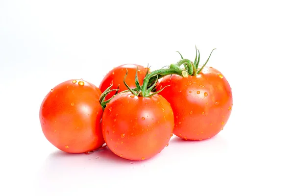 Fresh tomatoes with green leaves isolated on white background — Stock Photo, Image