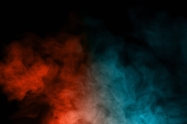 Close-up of color smoke with spray from a humidifier. Isolated on black background