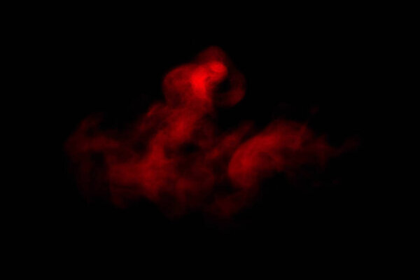 Close-up of floating red steam smoke spray isolated on a black background