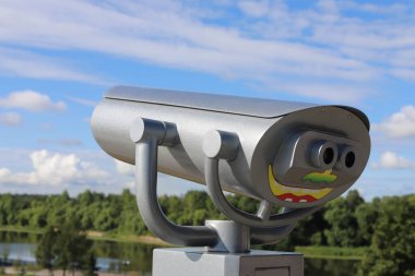 tourist spyglass on the observation deck, of the embankment of the arrow city Yaroslavl Russia in the form of a smiling face with a view of the city