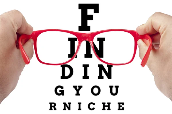 Red spectacles focusing on text Finding your niche arranged as eye chart test — Stock Photo, Image