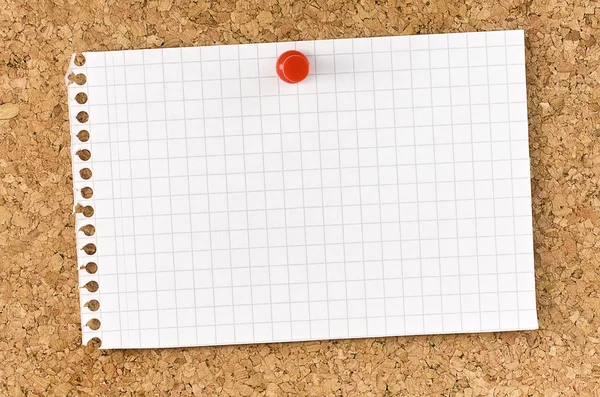 Blank squared note page fixed on cork board with thumb tack — Stock Photo, Image