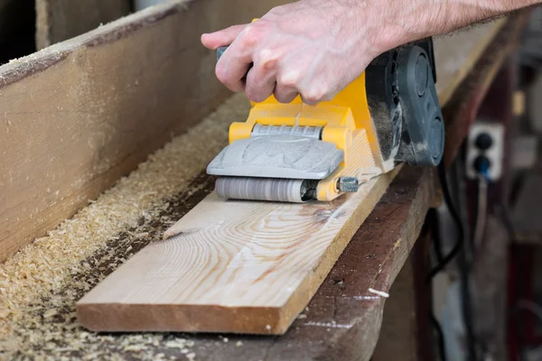 Carpenter works with belt sander in carpentry — Stock Photo, Image