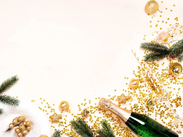Green bottle of champagne with gold confetti and Christmas ornaments — Stock Photo, Image