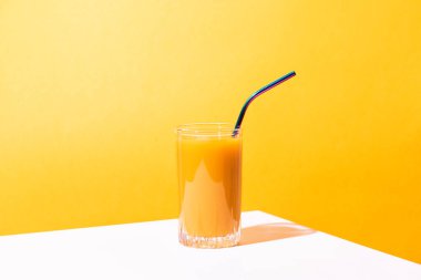 Bir bardak taze mango suyu kokteyli ve palmiye dalları.