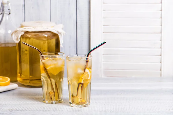 Homemade fermented kombucha tea drink with lemon and ginger