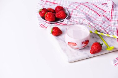 Bir bardak ev yapımı organik çilekli yoğurt ve taze çilek.