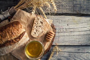 Dilimlenmiş ekmek, bal, buğday, rustik ahşap arka plan