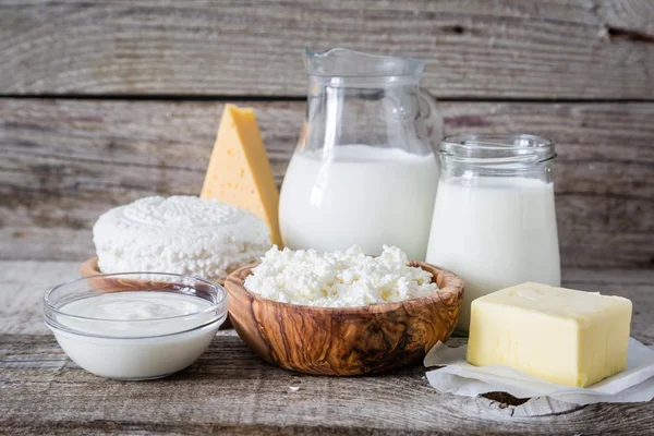 Selection of dairy products on rustic wood bacground — Stock Photo, Image