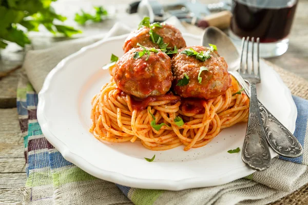 Meat balls and spaghetti on white plate