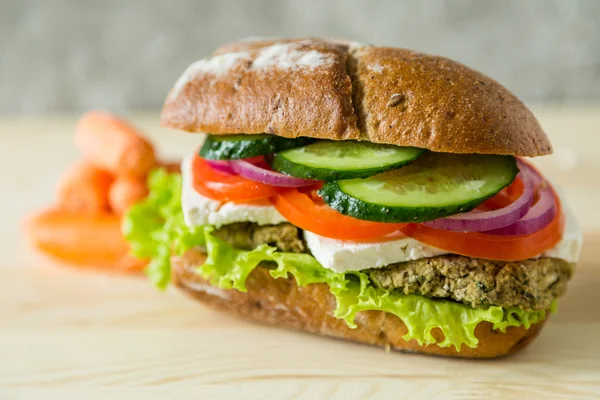 Vegan sandwich in lunch box with carrots and nuts — Stock Photo, Image