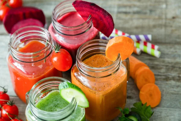 Selection of colorful vegetable juices in glass jars — Stock Photo, Image