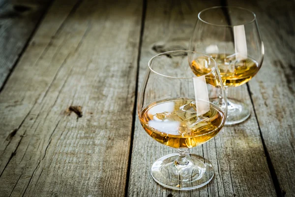 Cognac in bril op rustieke backgrpund — Stockfoto